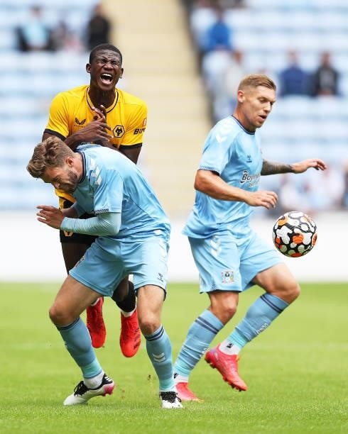 Yerson Mosquera of Wolverhampton Wanderers is challenged during the Pre-Season Friendly between Coventry City and Wolverhampton Wanderers at Ricoh...