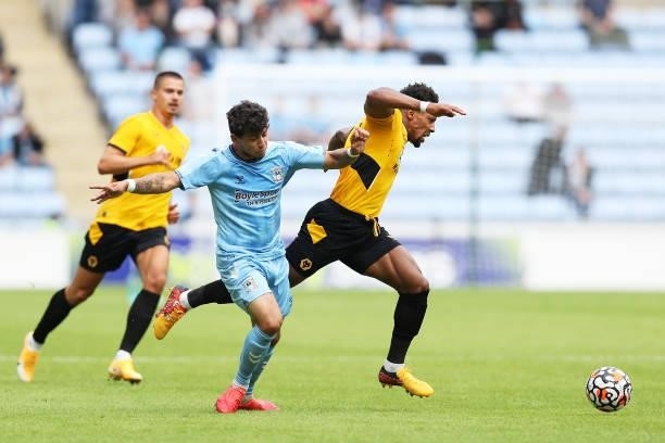 Adama Traore of Wolverhampton Wanderers is challenged by Gustavo Hamer of Coventry City during the Pre-Season Friendly between Coventry City and...