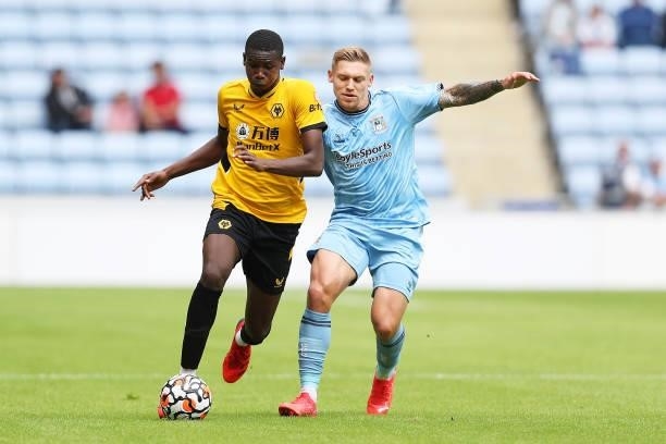 Yerson Mosquera of Wolverhampton Wanderers is challenged by Martyn Waghorn of Coventry City during the Pre-Season Friendly between Coventry City and...