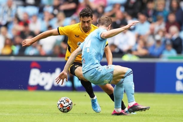Maximilian Kilman of Wolverhampton Wanderers runs with the ball under pressure from Ben Sheaf of Coventry City during the Pre-Season Friendly between...