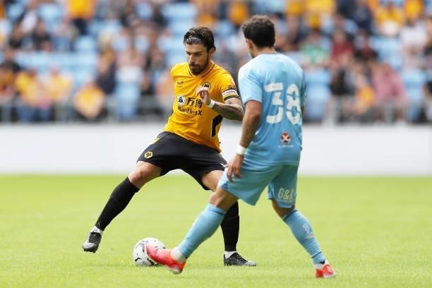 Ruben Neves of Wolverhampton Wanderers is challenged by Gustavo Hamer of Coventry City during the Pre-Season Friendly between Coventry City and...
