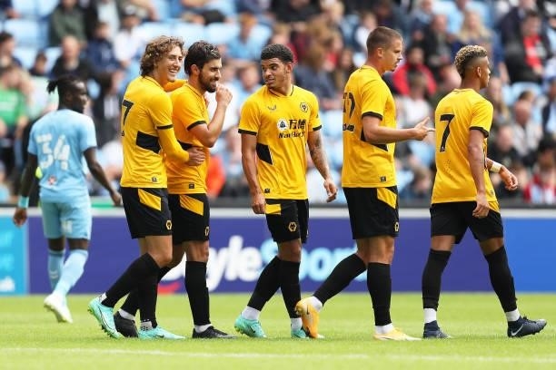 Ruben Neves of Wolverhampton Wanderers celebrates scoring his team's second goal with teammates during the Pre-Season Friendly between Coventry City...