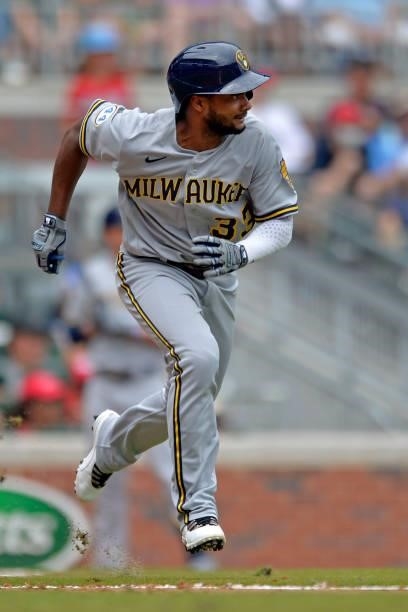 Pablo Reyes of the Milwaukee Brewers runs to first base during a game against the Atlanta Braves at Truist Park on August 1, 2021 in Atlanta, Georgia.