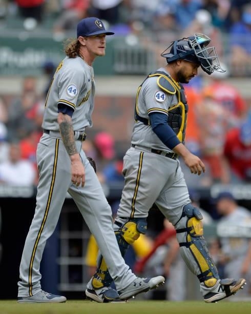 Josh Hader and Omar Narváez of the Milwaukee Brewers walk off the field after winning against the Atlanta Braves at Truist Park on August 1, 2021 in...