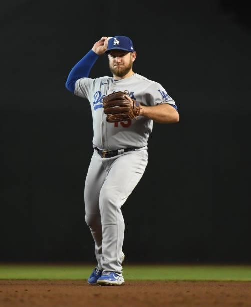 Max Muncy of the Los Angeles Dodgers makes a throw to first base against the Arizona Diamondbacks at Chase Field on July 31, 2021 in Phoenix, Arizona.