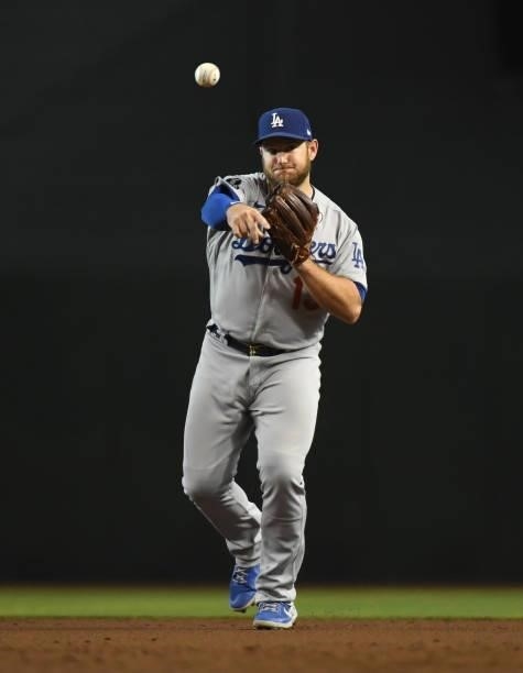 Max Muncy of the Los Angeles Dodgers makes a throw to first base against the Arizona Diamondbacks at Chase Field on July 31, 2021 in Phoenix, Arizona.