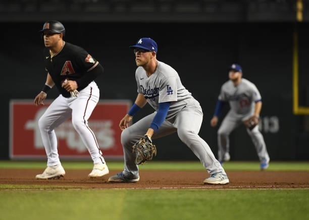 Matt Beaty of the Los Angeles Dodgers gets ready to make a play at first base against the Arizona Diamondbacks at Chase Field on July 31, 2021 in...