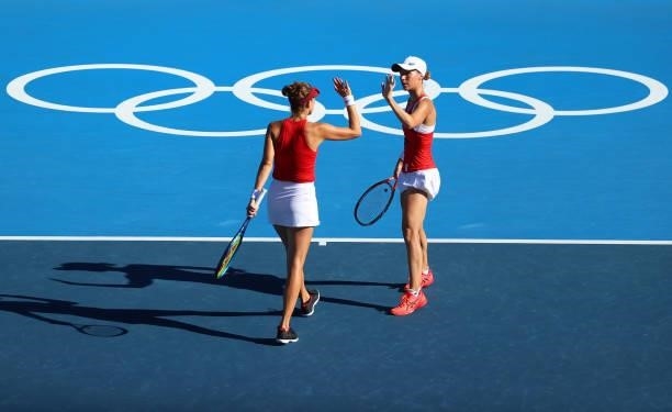 Belinda Bencic and Viktorija Golubic of Team Switzerland celebrate against Barbora Krejcikova and Katerina Siniakova of Team Czech Republic during...