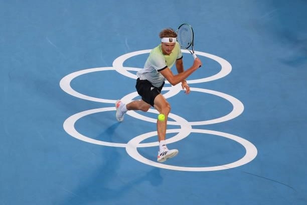 Alexander Zverev of Team Germany hits a backhand against Karen Khachanov of Team Russian Olympic Committee during the Men's Singles Gold Medal Match...