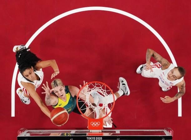 Cayla George of Team Australia drives to the basket against Isalys Quinones of Team Puerto Rico as Jazmon Gwathmey looks on during the 2nd half of a...