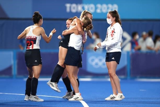 Hannah Martin of Team Great Britain is congratulated by a member of Team Great Britain following victory in the Women's Quarterfinal match between...
