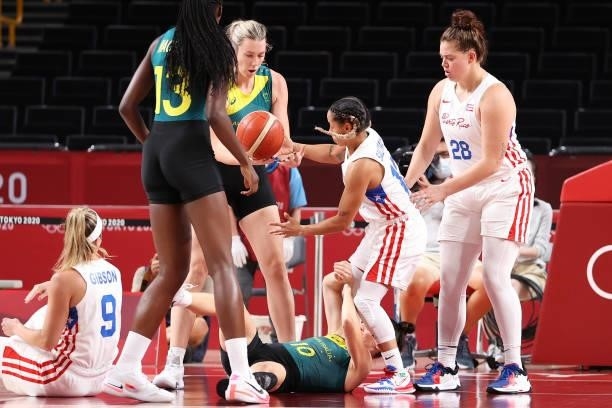 Sara Blicavs of Team Australia and Dayshalee Salaman of Team Puerto Rico fight for possession of a loose ball as Sabrina Lozada-Cabbage looks on...