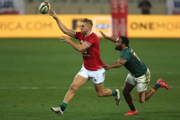 Chris Harris of the British & Irish Lions gets his pass away as Lukhanyo Am of South Africa closes in during the second test between South Africa and...