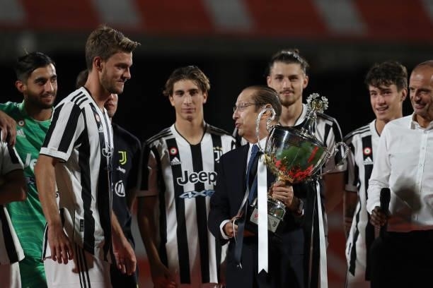 Paolo Berlusconi Chairman of AC monza hands over the trophy to Daniele Rugani of Juventus following the Trofeo Berlusconi match between AC Monza and...