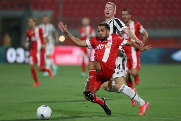 Giuseppe Bellusci of AC Monza stretches to control the ball under pressure from Dejan Kulusevski of Juventus during the Trofeo Berlusconi match...