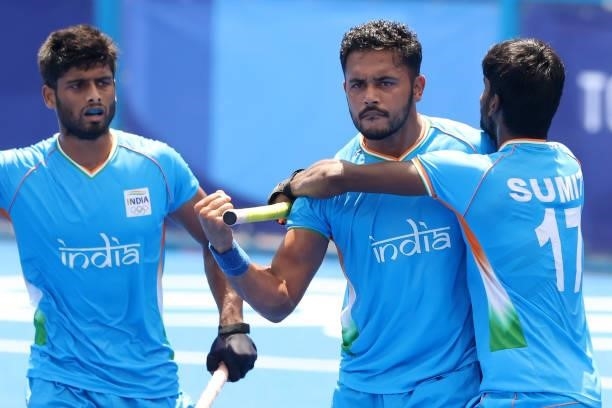 Harmanpreet Singh celebrates scoring the first goal with Sumit and Varun Kumar during the Men's Semifinal match between India and Belgium on day...