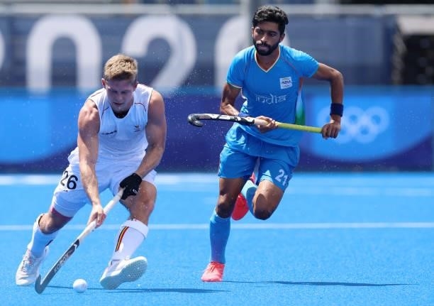 Victor Nicky B Wegnez of Team Belgium moves the ball past Shamsher Singh of Team India during the Men's Semifinal match between India and Belgium on...