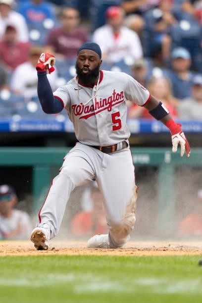 Josh Harrison of the Washington Nationals slides home safely against the Philadelphia Phillies during Game One of the doubleheader at Citizens Bank...