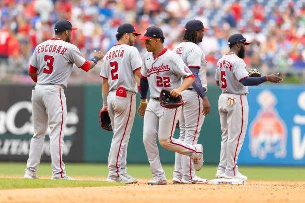 Juan Soto of the Washington Nationals celebrates with Alcides Escobar, Luis Garcia, Josh Bell, and Josh Harrison after the game against the...