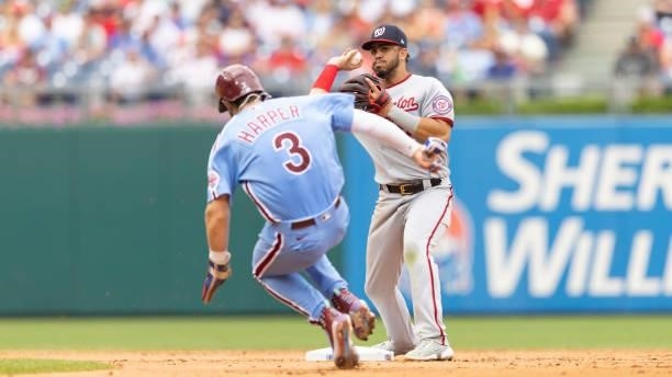 Luis Garcia of the Washington Nationals attempts to turn a double play against Bryce Harper of the Philadelphia Phillies during Game One of the...