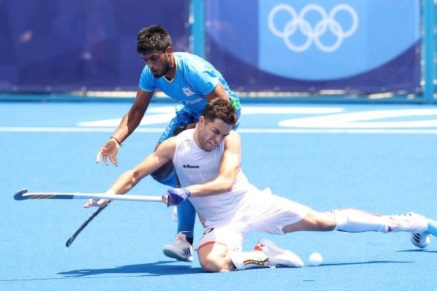 Cedric Daniel Andre Charlier of Team Belgium and Varun Kumar of Team India battle for a loose ball during the Men's Semifinal match between India and...