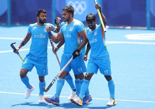Harmanpreet Singh celebrates scoring the first goal with Sumit and Varun Kumar during the Men's Semifinal match between India and Belgium on day...
