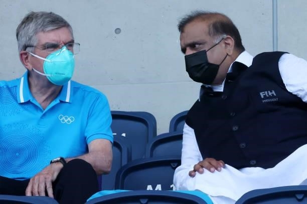 President Thomas Bach and IHF President Narinder Dhruv Batra look on during the Men's Semifinal match between India and Belgium on day eleven of the...