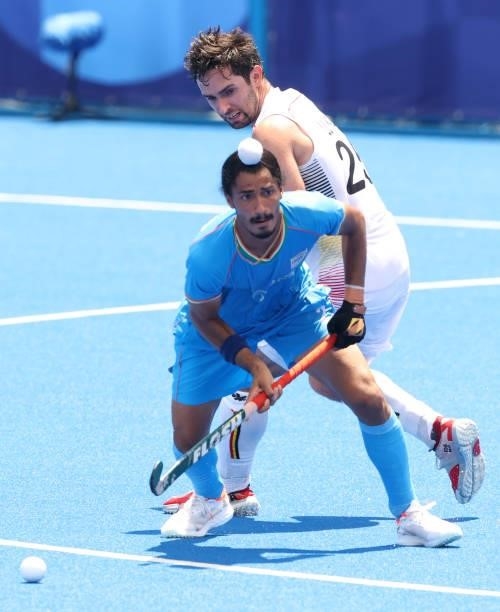 Mandeep Singh of Team India moves the ball past Loick Fanny A Luypaert of Team Belgium during the Men's Semifinal match between India and Belgium on...