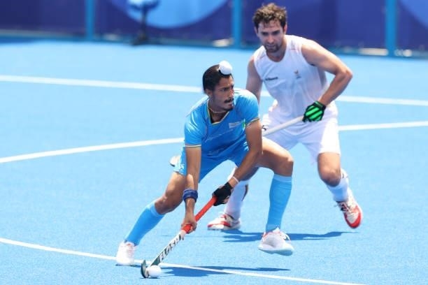 Mandeep Singh of Team India moves the ball past Loick Fanny A Luypaert of Team Belgium during the Men's Semifinal match between India and Belgium on...
