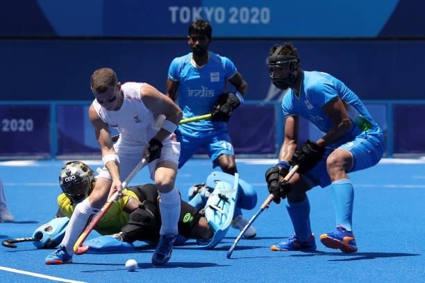 John-John Dominique M Dohmen of Team Belgium controls the ball defended by Sreejesh Parattu Raveendran and Rupinder Pal Singh of Team India during...