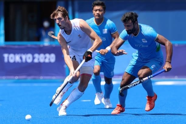 Antoine Sylvain T Kina of Team Belgium moves the ball past Surender Kumar of Team India during the Men's Semifinal match between India and Belgium on...