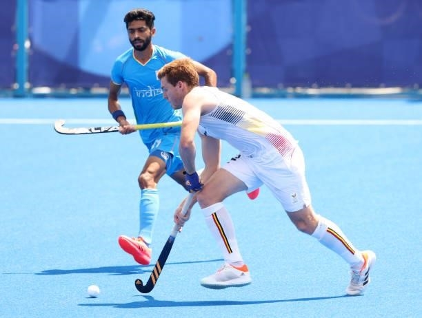 Gauthier Boccard of Team Belgium moves the ball past Shamsher Singh of Team India during the Men's Semifinal match between India and Belgium on day...