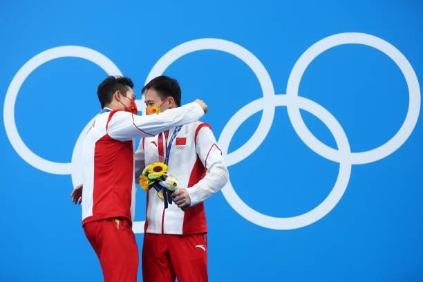 Silver medalist Wang Zongyuan of Team China and gold medalist Xie Siyi of Team China celerbate during the medal ceremony for the Men's 3m Springboard...