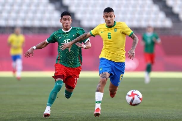 Guilherme Arana of Team Brazil battles for possession with Uriel Antuna of Team Mexico during the Men's Football Semi-final match between Mexico and...