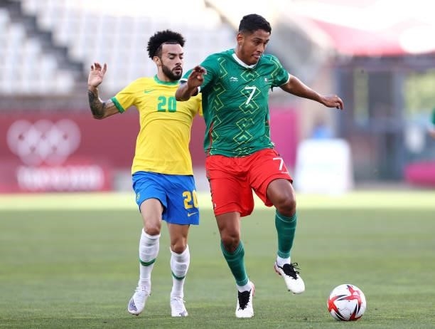 Luis Romo of Team Mexico is challenged by Claudinho of Team Brazil during the Men's Football Semi-final match between Mexico and Brazil on day eleven...