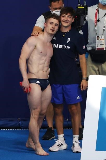 Jack Laugher of Team Great Britain celebrates with his coach Adam Smallwood after his final dive in the Men's 3m Springboard Final on day eleven of...