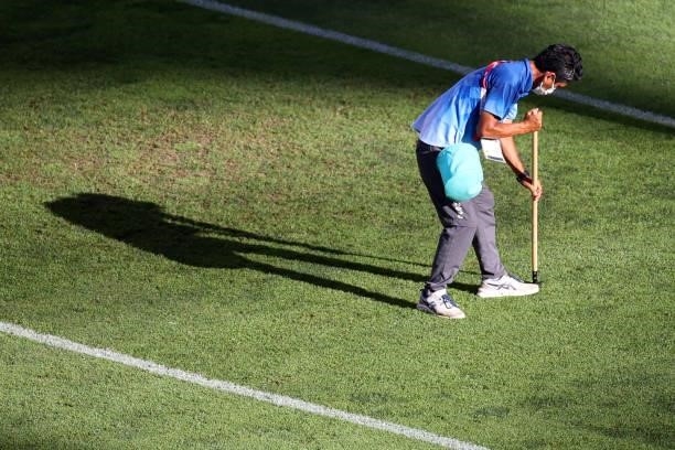 Member of ground staff prepares the pitch prior to the Men's Football Semi-final match between Mexico and Brazil on day eleven of the Tokyo 2020...