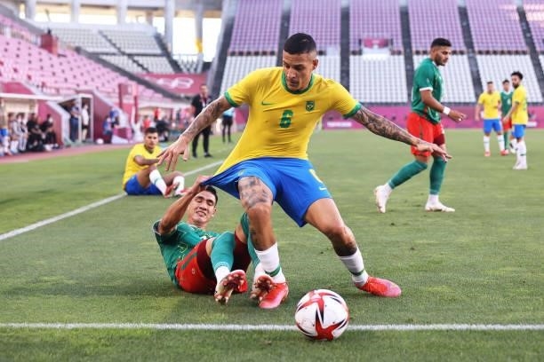 Guilherme Arana of Team Brazil is challenged by Uriel Antuna of Team Mexico during the Men's Football Semi-final match between Mexico and Brazil on...
