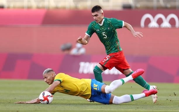 Richarlison of Team Brazil is challenged by,Johan Vasquez of Team Mexico during the Men's Football Semi-final match between Mexico and Brazil on day...