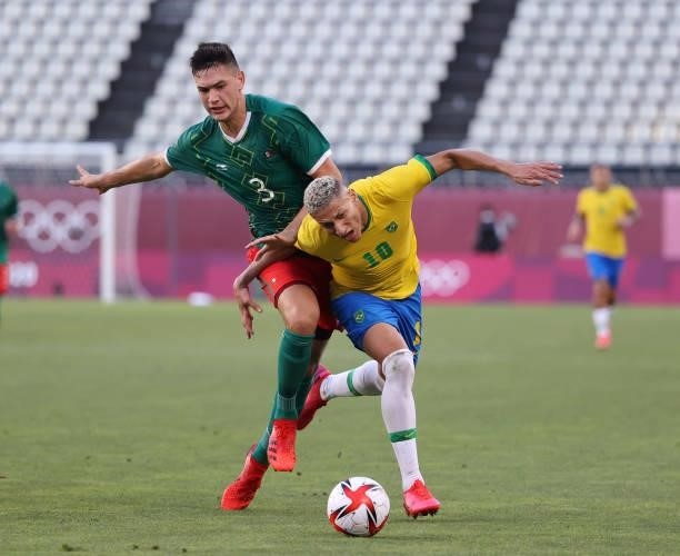 Richarlison of Team Brazil battles for possession with Joaquin Esquivel of Team Mexico during the Men's Football Semi-final match between Mexico and...