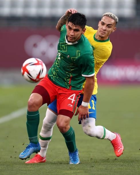 Jesus Angulo of Team Mexico shields the ball away from Antony of Team Brazil during the Men's Football Semi-final match between Mexico and Brazil on...