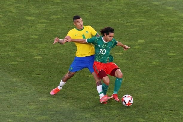 Diego Lainez of Team Mexico is challenged by Guilherme Arana of Team Brazil during the Men's Football Semi-final match between Mexico and Brazil on...