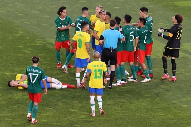 Reinier of Team Brazil clashes with Vladimir Lorona of Team Mexico as Gabriel Martinelli of Team Brazil lies injured on the ground during the Men's...