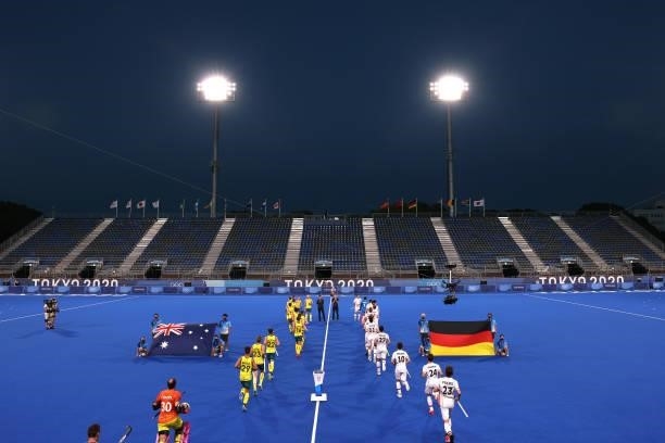 Players of both teams run to pitch for their national anthems prior to the Men's Semifinal match between Australia and Germany on day eleven of the...