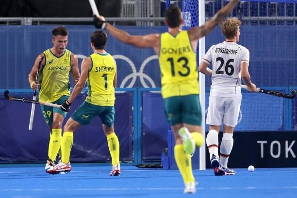 Tim Brand of Team Australia celebrates with teammate Lachlan Thomas Sharp after scoring their team's first goal during the Men's Semifinal match...