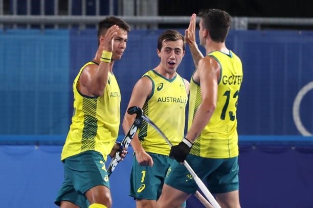 Tim Brand of Team Australia celebrates with teammates Lachlan Thomas Sharp and Blake Govers after scoring their team's first goal during the Men's...