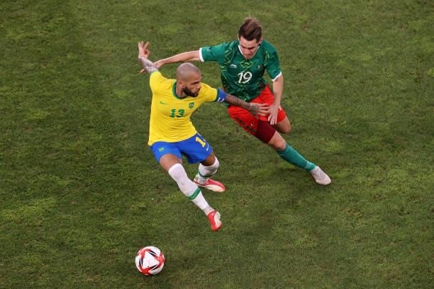 Dani Alves of Team Brazil battles for possession with Ricardo Angulo of Team Mexico during the Men's Football Semi-final match between Mexico and...