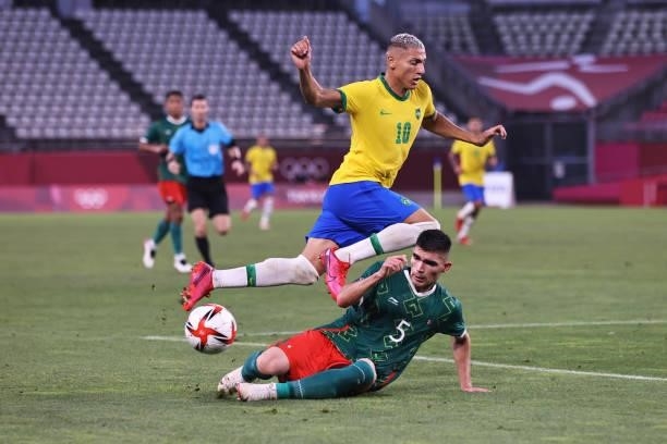 Richarlison of Team Brazil is challenged by Johan Vasquez of Team Mexico during the Men's Football Semi-final match between Mexico and Brazil on day...