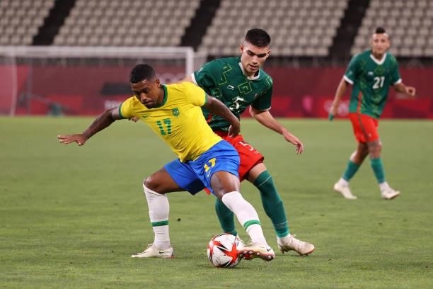 Malcom of Team Brazil shields the ball from Johan Vasquez of Team Mexico during the Men's Football Semi-final match between Mexico and Brazil on day...
