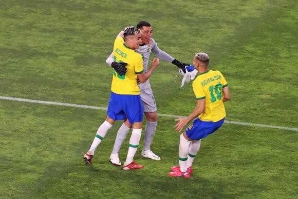 Santos, Reinier and Richarlison of Team Brazil celebrates their side's victory in the penalty shoot out after the Men's Football Semi-final match...